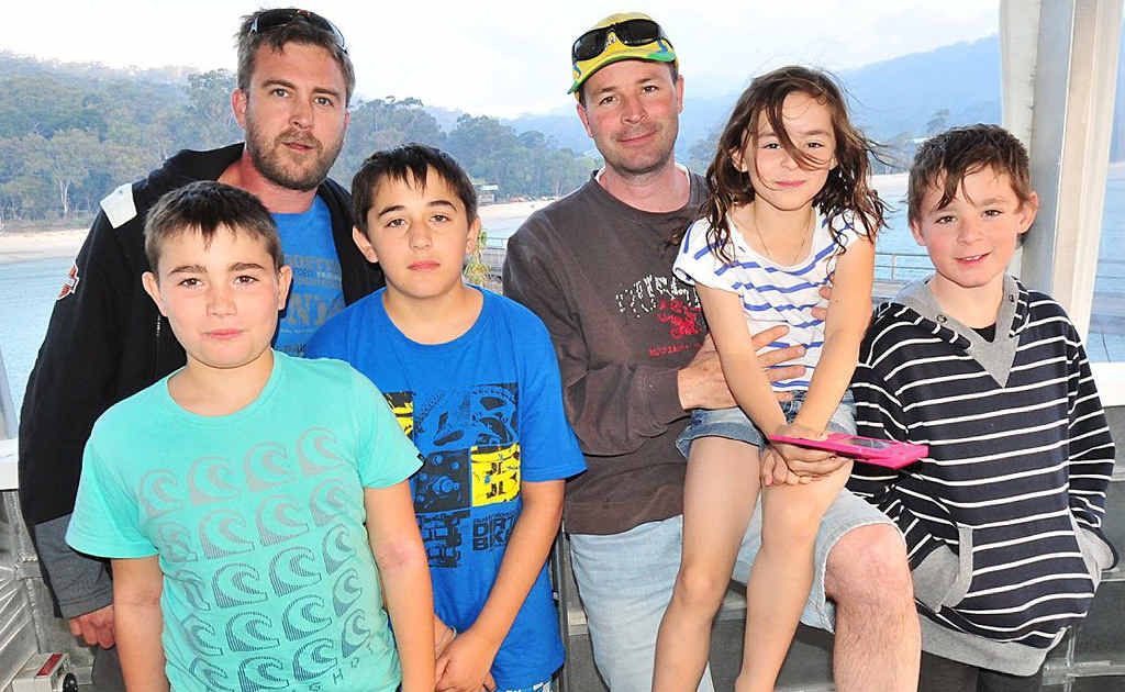 Visitors from Sydney Jason Dillaway and Stephen Grassmayr with children Patrick, Lawrance, Brodie, Lindsay and Isaac leave Fraser Island after their holiday accommodation was evacuated. Visitors from Sydney Jason Dillaway and Stephen Grassmayr with children Patrick, Lawrance, Brodie, Lindsay and Isaac leave Fraser Island after their holiday accommodation was evacuated.